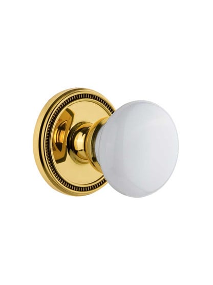 Grandeur Soleil Rosette Door Set with Hyde Park Porcelain Knobs in Polished Brass.